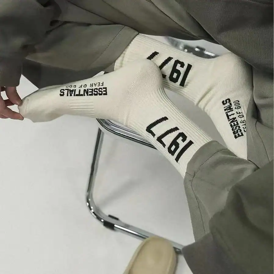 Kpop merch, twice kpop merch, K-pop merchandise socks, white socks with black text, fans wearing trendy K-pop themed apparel.