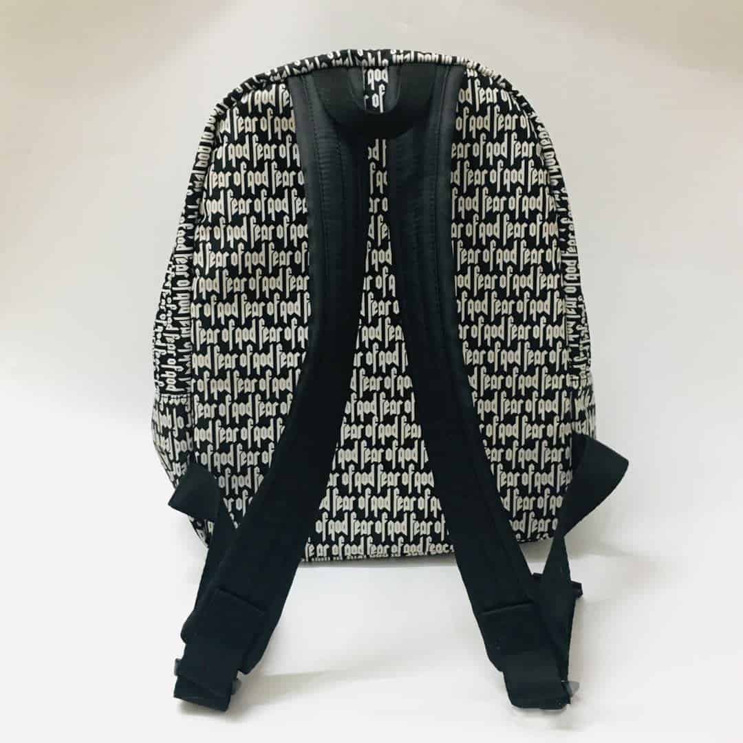 Backpack with "twice kpop merch" text pattern, black and white design, suitable for K-pop fans, featuring adjustable straps and spacious interior.