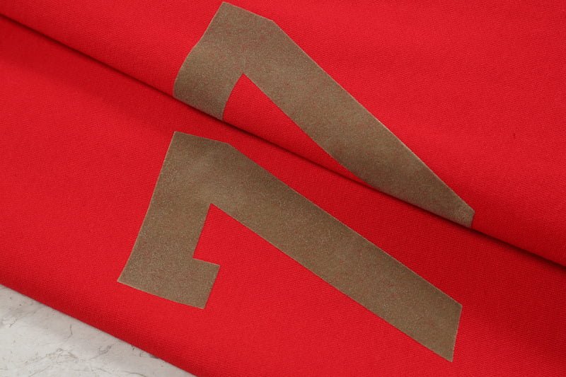 Red K-pop merchandise packaging with bold black lettering, showcasing the vibrant design and trendy style of official K-pop group goods. Perfect for fans and collectors.