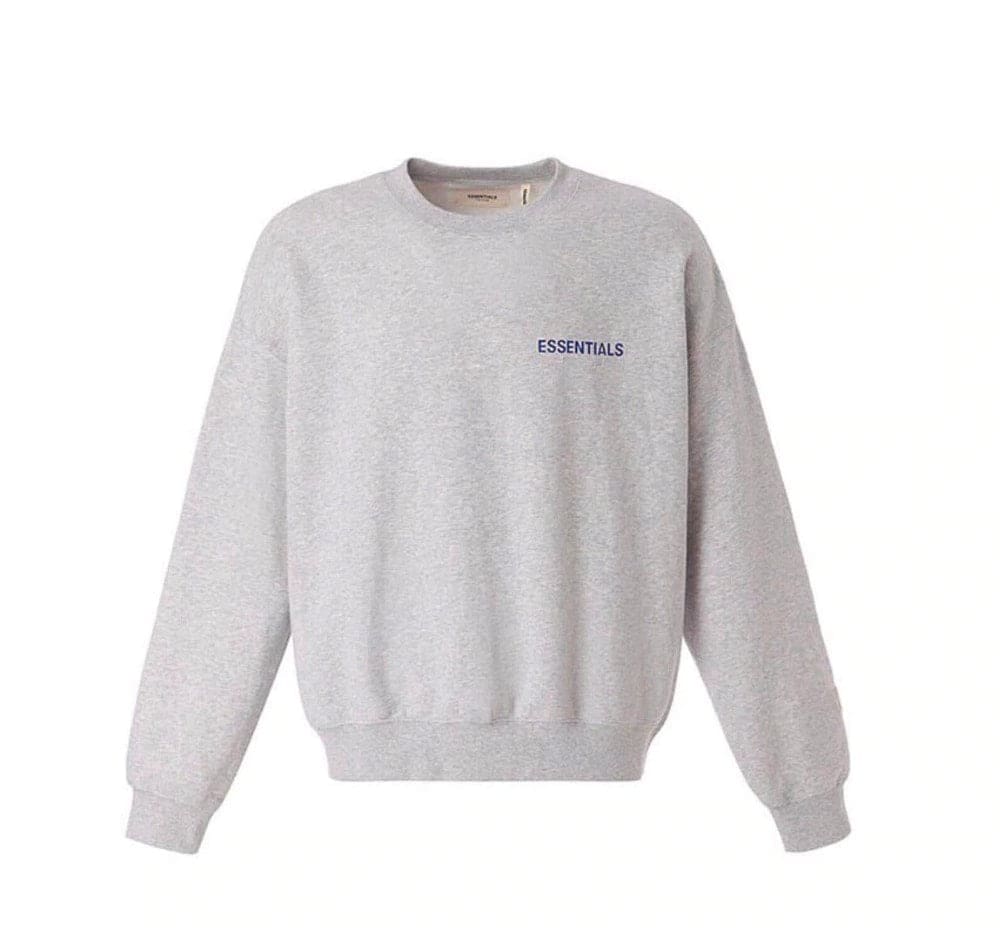 Crewneck sweatshirt with "ESSENTIALS" text in small font, light gray color, casual style, suitable for K-pop fans, unisex design, made of soft fabric.