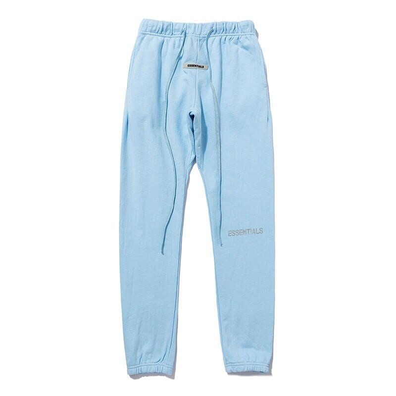 Sweatpants with "ESSENTIALS" logo in light blue, casual and stylish, perfect for loungewear or streetwear outfits for K-pop fans.
