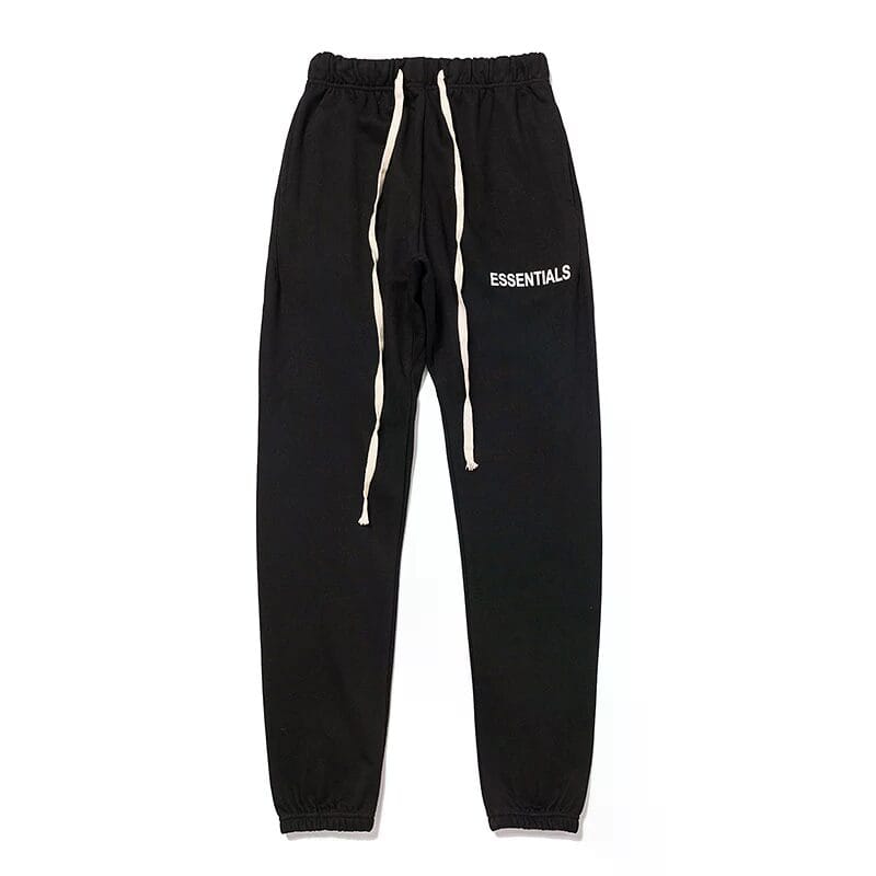 Black jogger pants with white drawstrings and "ESSENTIALS" logo, popular in K-pop fashion merchandise. Perfect for fans looking to showcase their love for Korean pop culture stylishly.