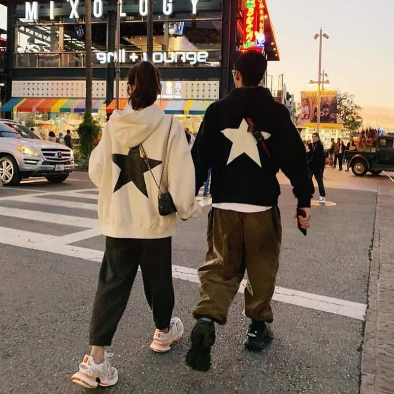 Matching kpop merch sets with star logo designs for fans of popular groups, ideal for fashion and collectibles, worn by stylish young people in casual streetwear.