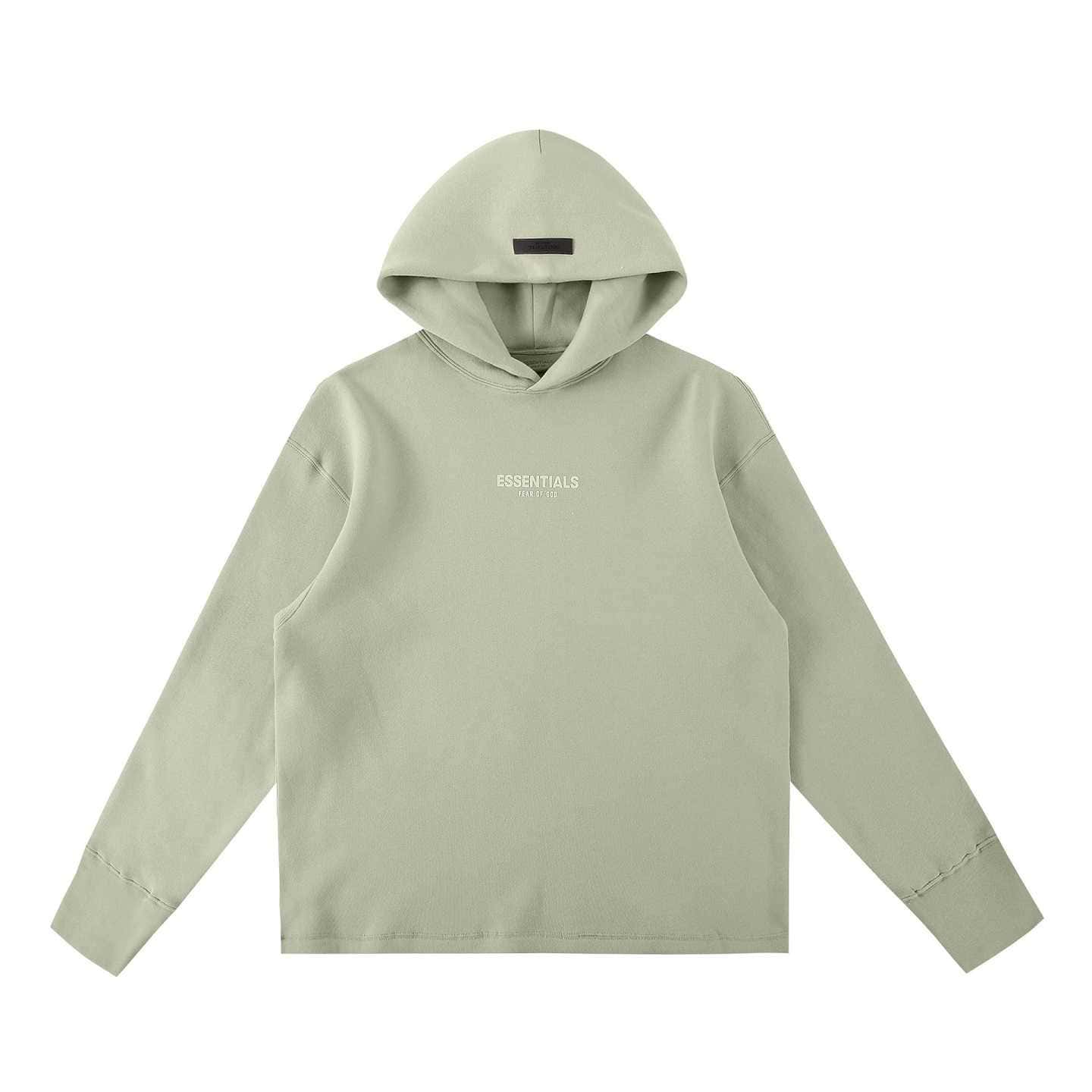 Soft pastel hoodie with "ESSENTIALS" logo in white on the chest, oversized fit, perfect for K-pop fans, part of trendy merch collections.