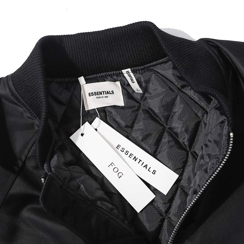Black bomber jacket with tags inside, premium quality streetwear fashion.