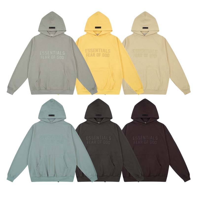 Grey, yellow, beige, blue, black, dark brown hoodies with "ESSENTIALS FEAR OF GOD" text for K-pop merchandise.