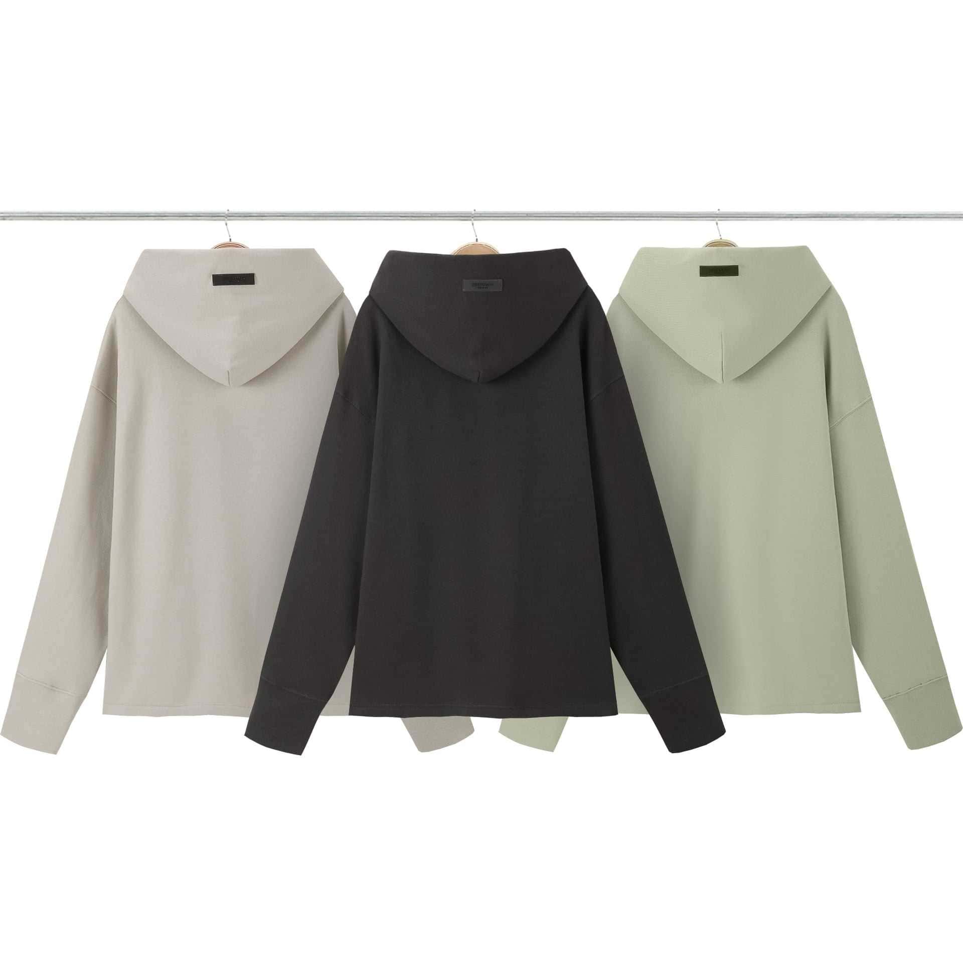 Oversized hoodies in neutral tones displayed on hangers, perfect for casual or streetwear fashion. Each hoodie features a large hood and relaxed fit, ideal for cozy, trendy looks. Twice Kpop merch.