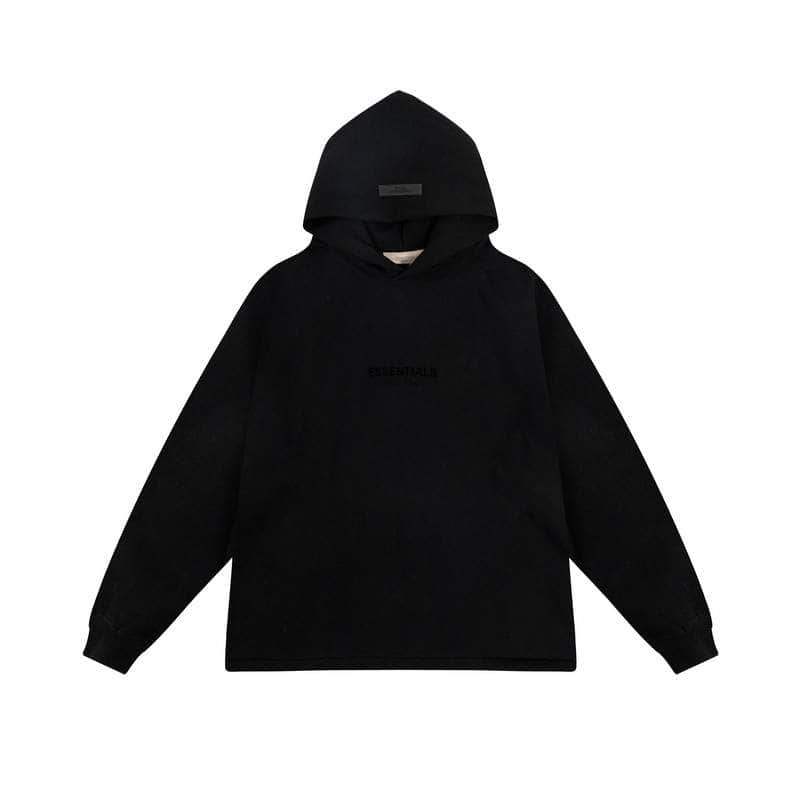 Black hoodie featuring minimalist design and subtle "ESSENTIALS" print, perfect for K-pop fans and streetwear enthusiasts.