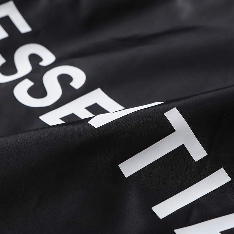 Black and white kpop merchandise with bold lettering and minimalistic design.