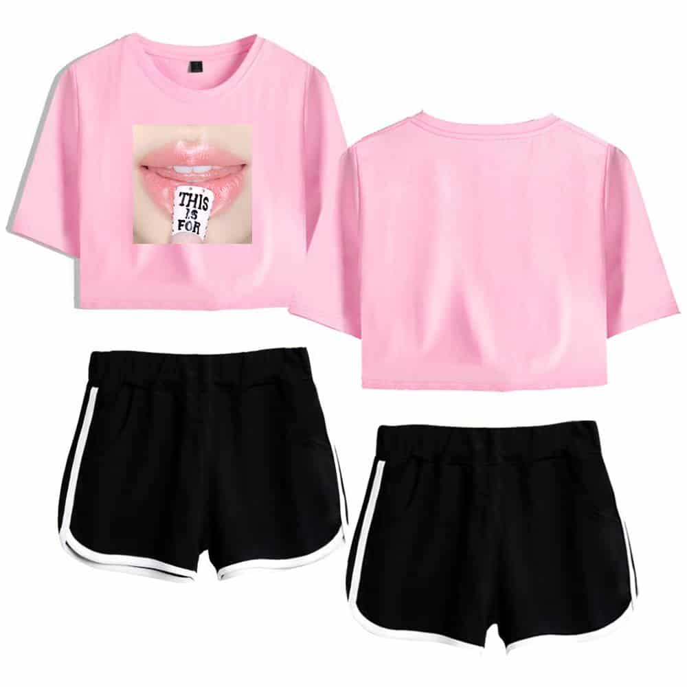 Pink cropped t-shirt with lips graphic and "this is for" text, paired with black athletic shorts with white trim, promoting trendy K-pop merchandise.