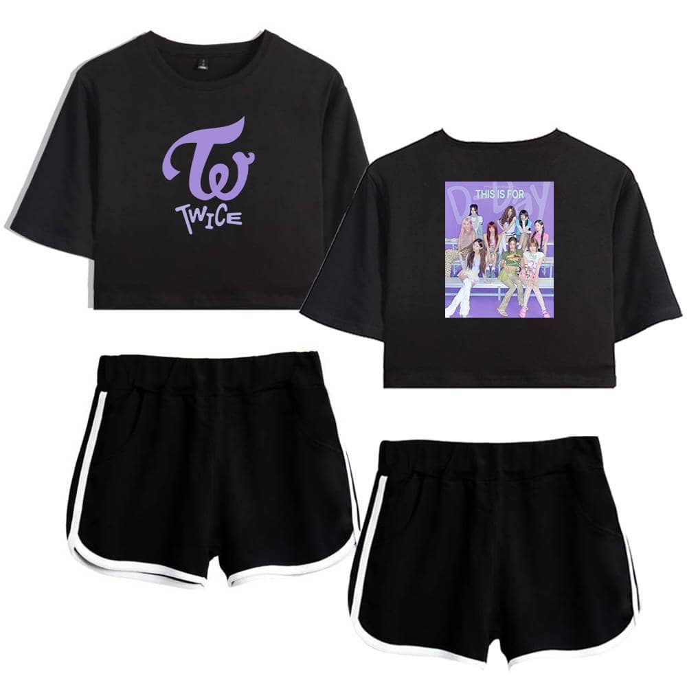 TWICE K-pop merchandise set featuring a black cropped T-shirt with the TWICE logo and a vibrant group photo, plus matching black athletic shorts with white trim. Perfect for fans and casual wear.